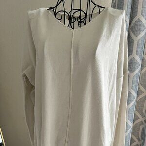 Cream colored v neck sweater with seam detailing